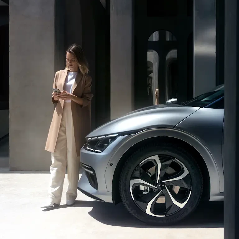Kia owner checking a vehicle before a drive